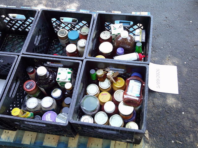 Glass jars and drinks in crates on a pallet